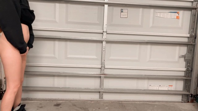 Hot college girl pees standing up in the garage at a party. Look how far she pissed